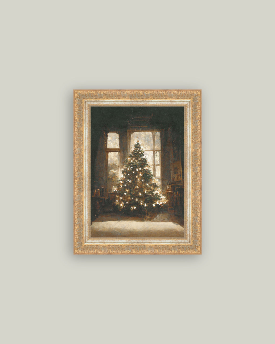 Framed artwork of a Christmas tree in a room with a gold frame on a light gray wall.