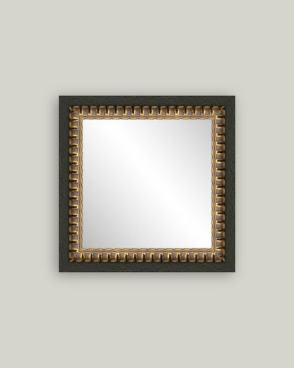 Decorative mirror with a black and gold frame on a light gray background
