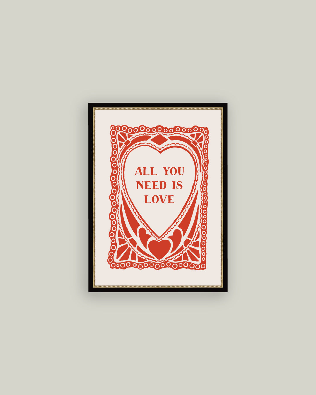 Framed artwork with 'All You Need Is Love' text on a gray wall