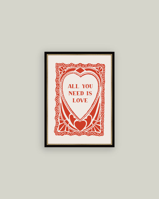 Framed artwork with 'All You Need Is Love' text on a gray wall